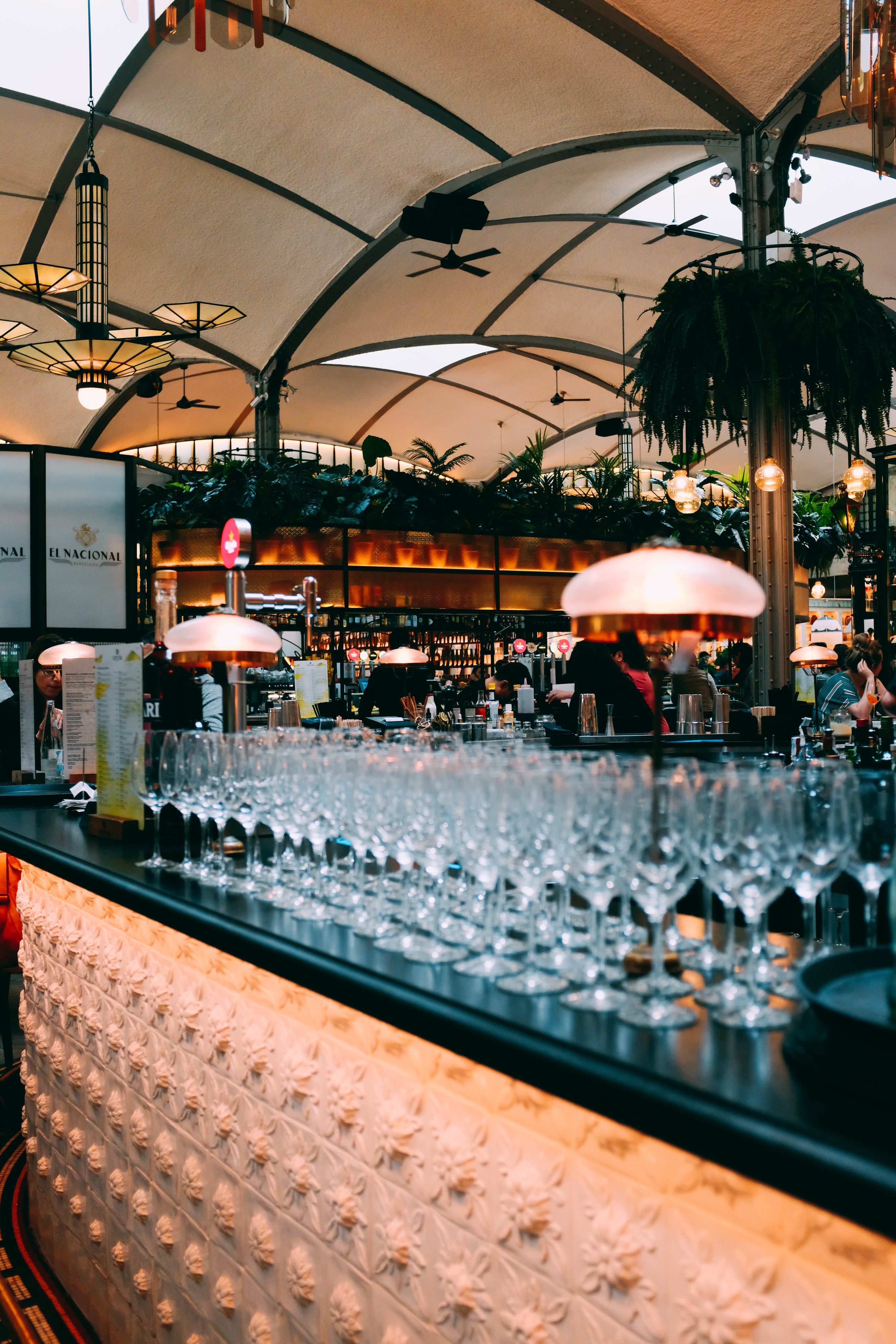 Wine glasses arranged on bar counter